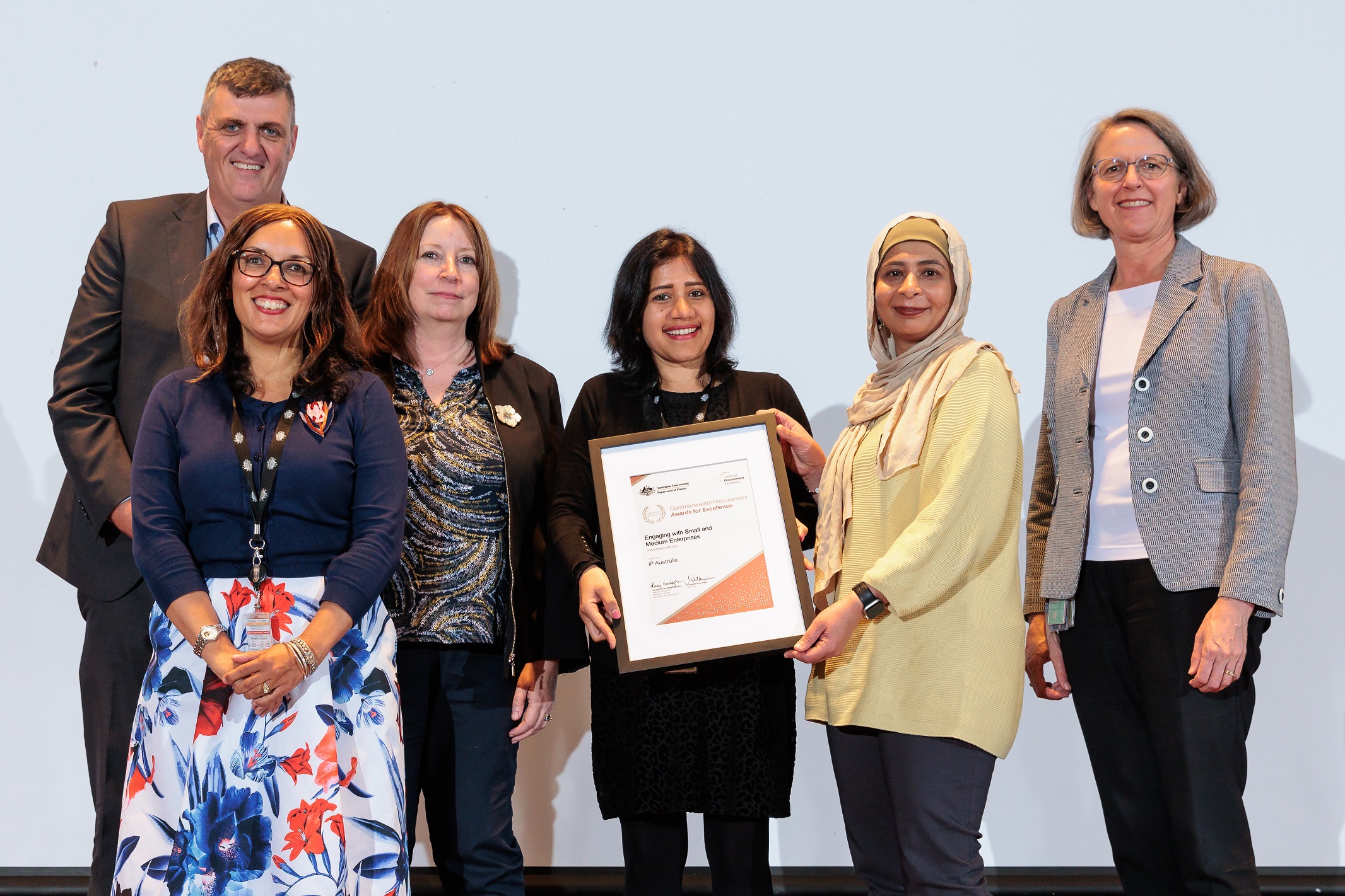 Photograph of Engaging with SMEs Honourable Mention award recipients – IP Australia with the Finance Secretary