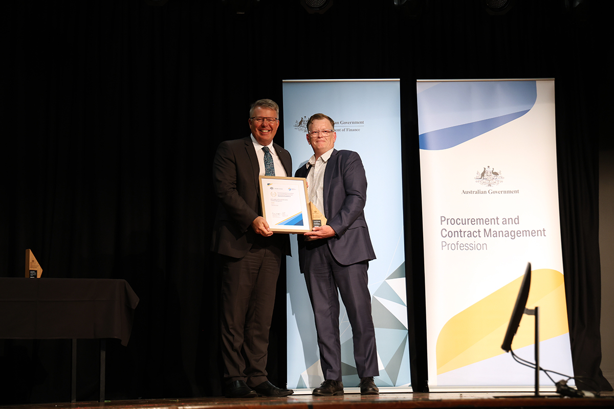 Gold Winner Luke McLeod with the Secretary of the Department of Finance